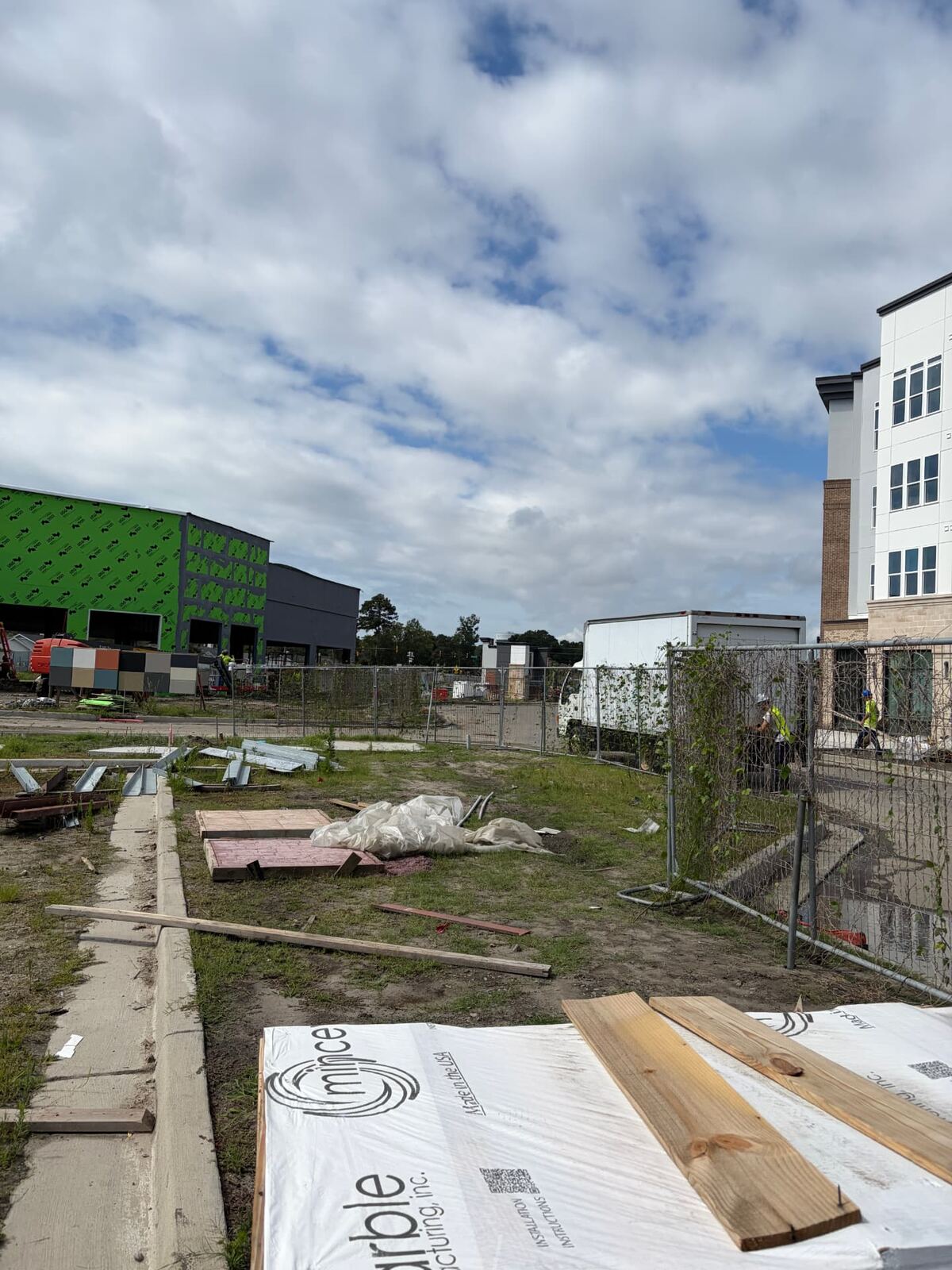 Temporary fencing securing an active commercial construction site