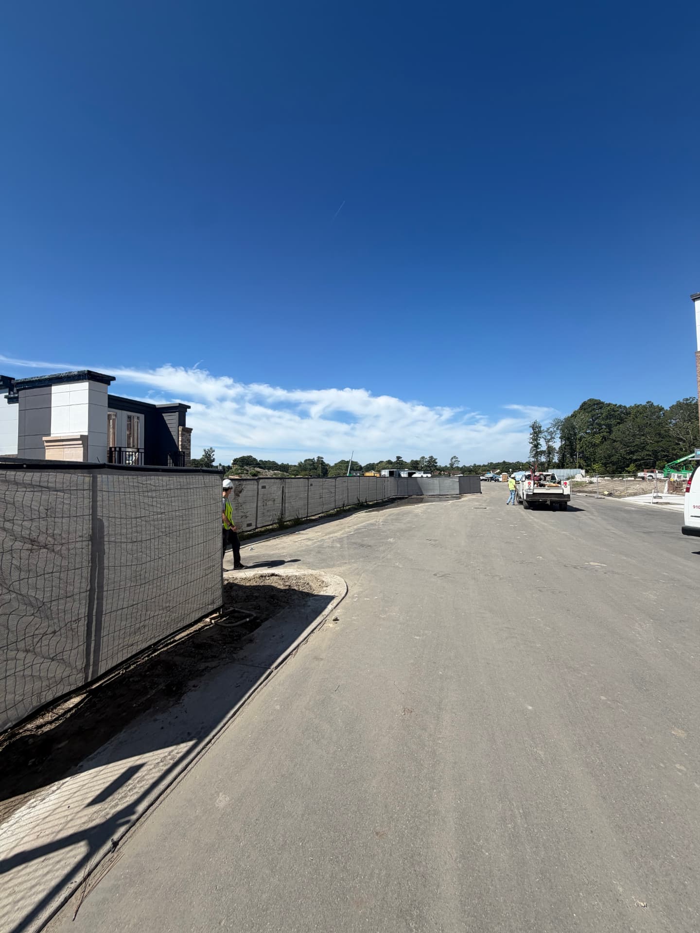 Temporary fence with screen lining a new subdivision street